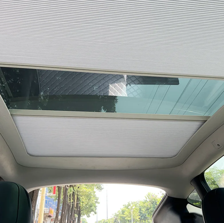 Roller sunroof shade deployed in a vehicle interior