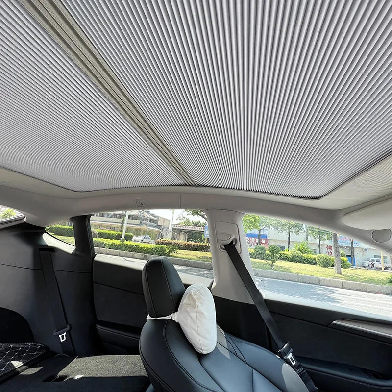 Roller sunroof shade deployed in a vehicle interior
